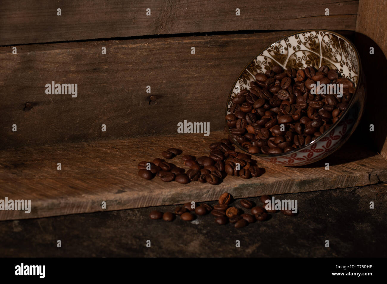Coffee beans spilling onto a wooden box Stock Photo
