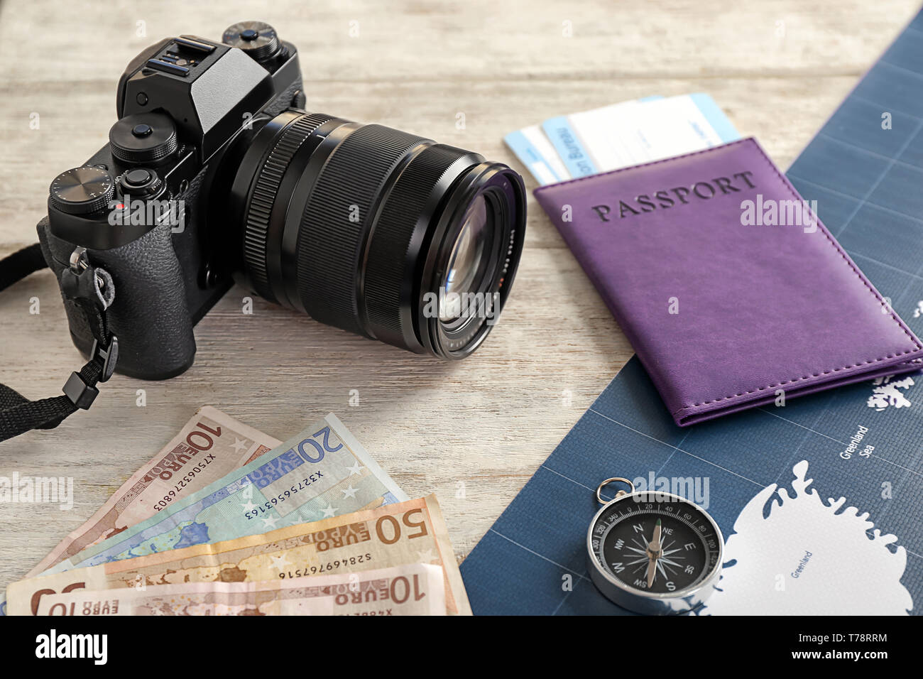 Composition with passport, camera and map on wooden background. Travel concept Stock Photo