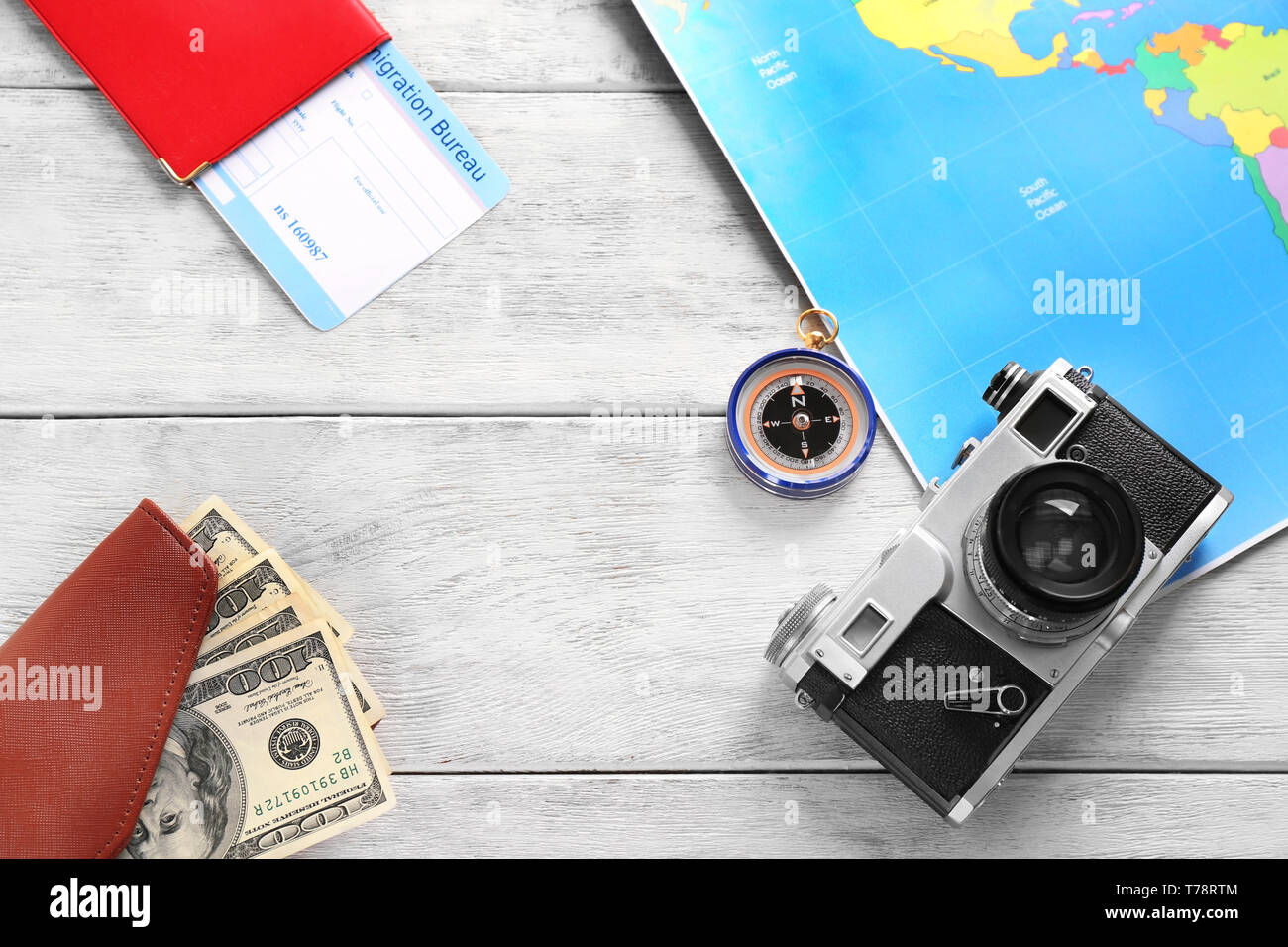 Composition with map, camera,money and passport on wooden background. Travel concept Stock Photo