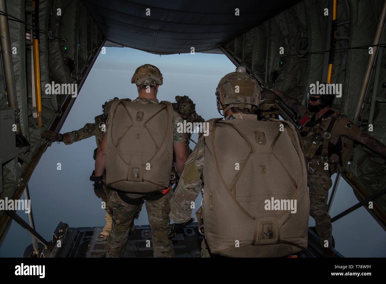 U.S. service members participate in a High Altitude Low Open (HALO) parachute jump from a C-130 Hercules near Camp Lemonnier, Djibouti, April 20, 2019. (U.S. Air Force Photo by Tech Sgt. Chris Hibben) Stock Photo