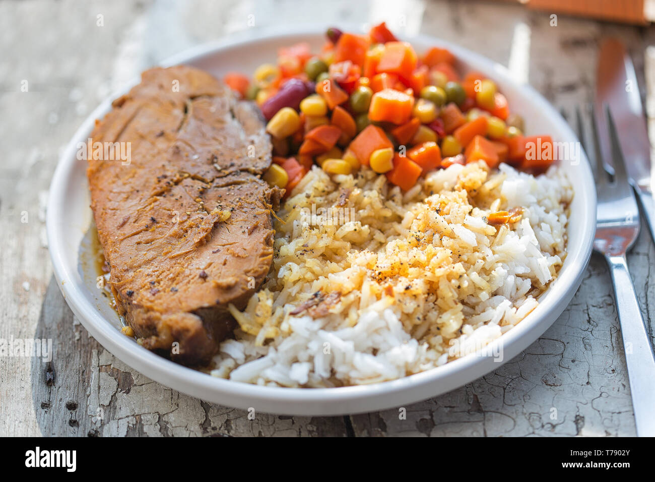 Pork roast with rice & vegetable salad Stock Photo - Alamy