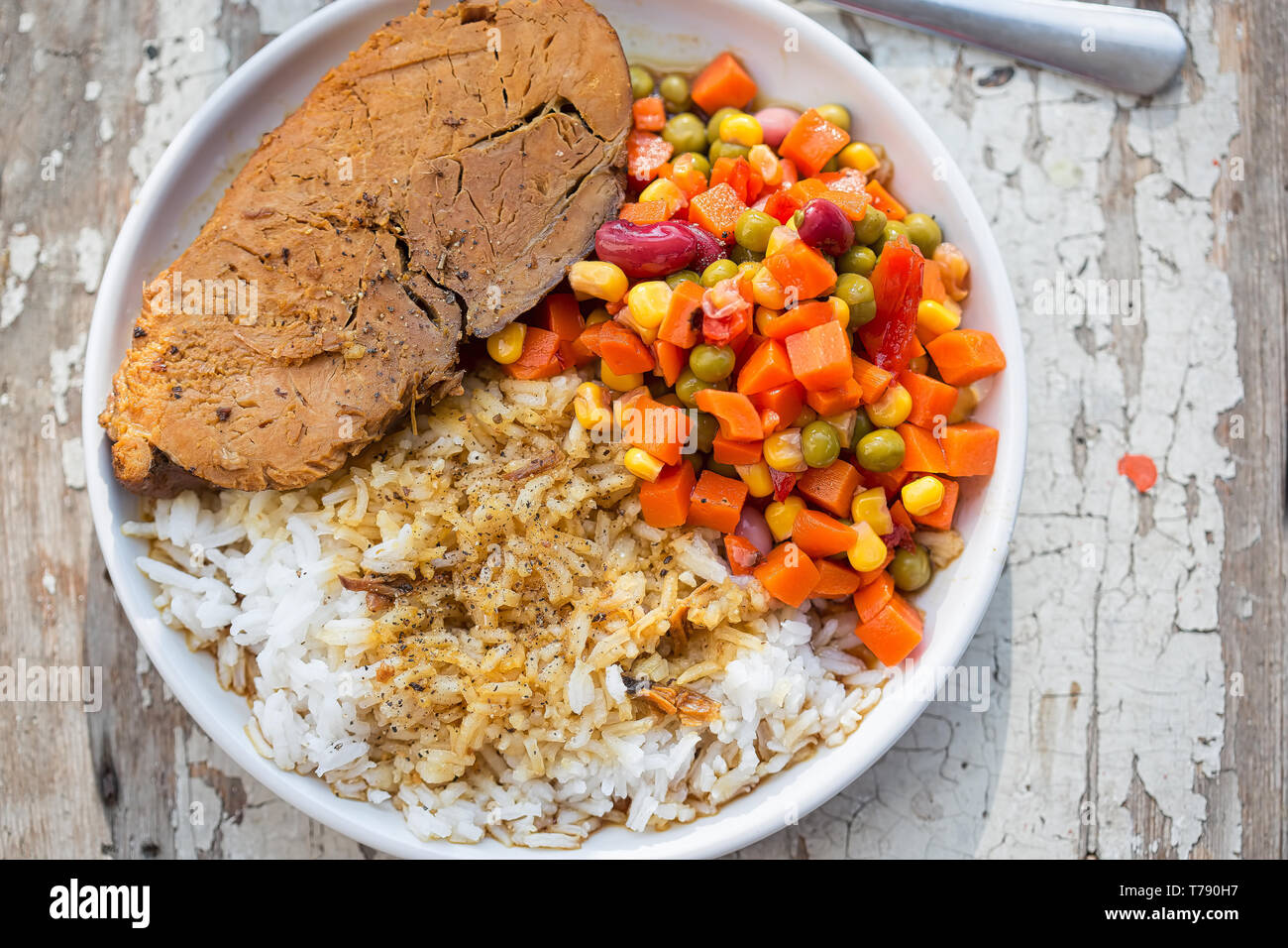Pork roast with rice & vegetable salad Stock Photo - Alamy