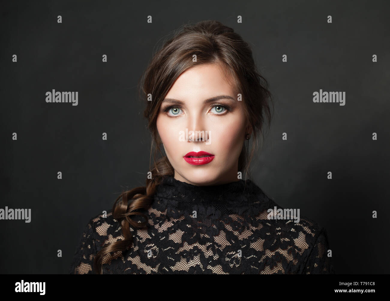 Pretty woman with red lips makeup hair on black background Stock Photo