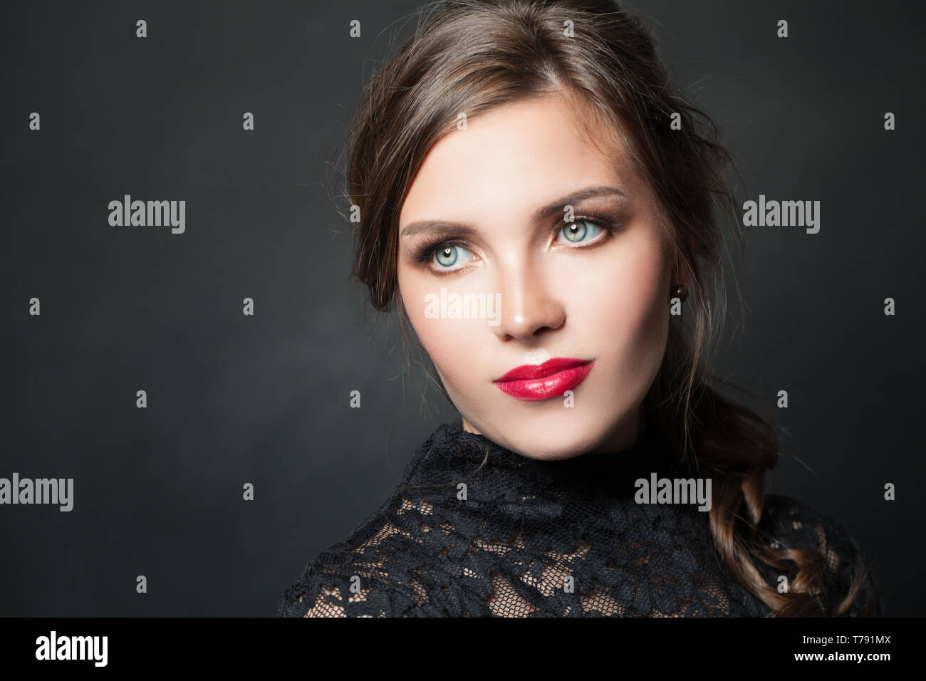 Stylish woman with red lips makeup hair on dark background Stock Photo