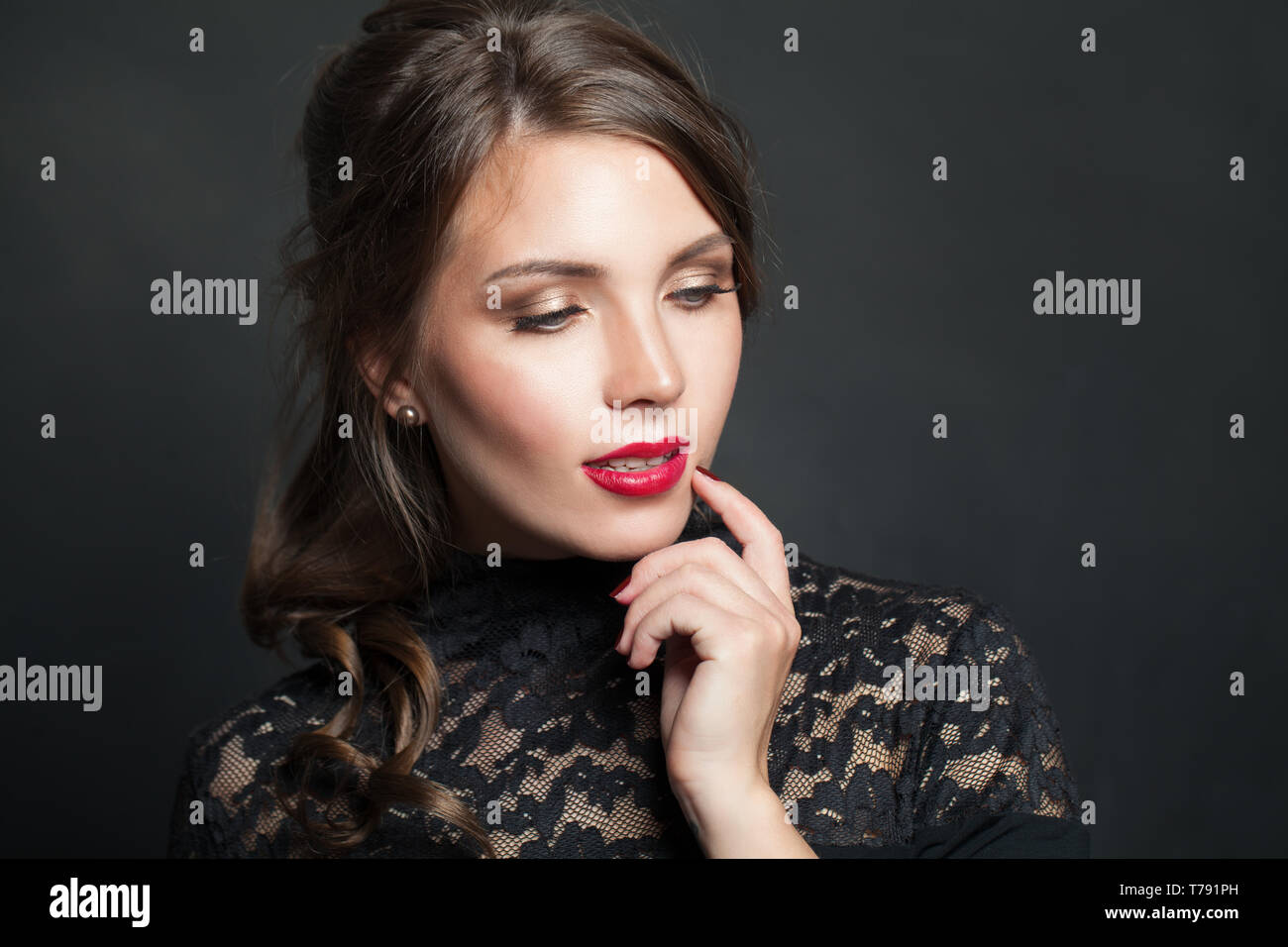 Portrait of beautiful woman with red lips makeup hair on dark background Stock Photo