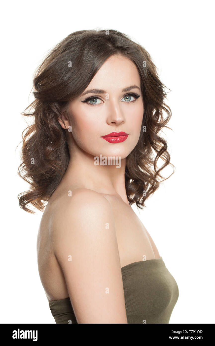 Cute brunette woman with perfect curly hair and makeup isolated on white background Stock Photo