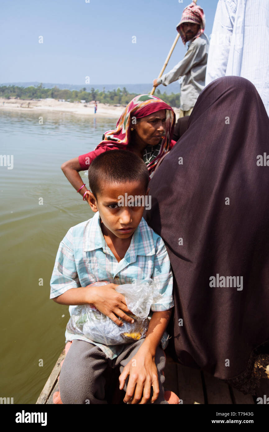 Jaflong, Sylhet, Bangladesh : A Bangladeshi family on a canoe crosses the Mari River, where whole families work 12 hours a day for about 1 dollar per  Stock Photo