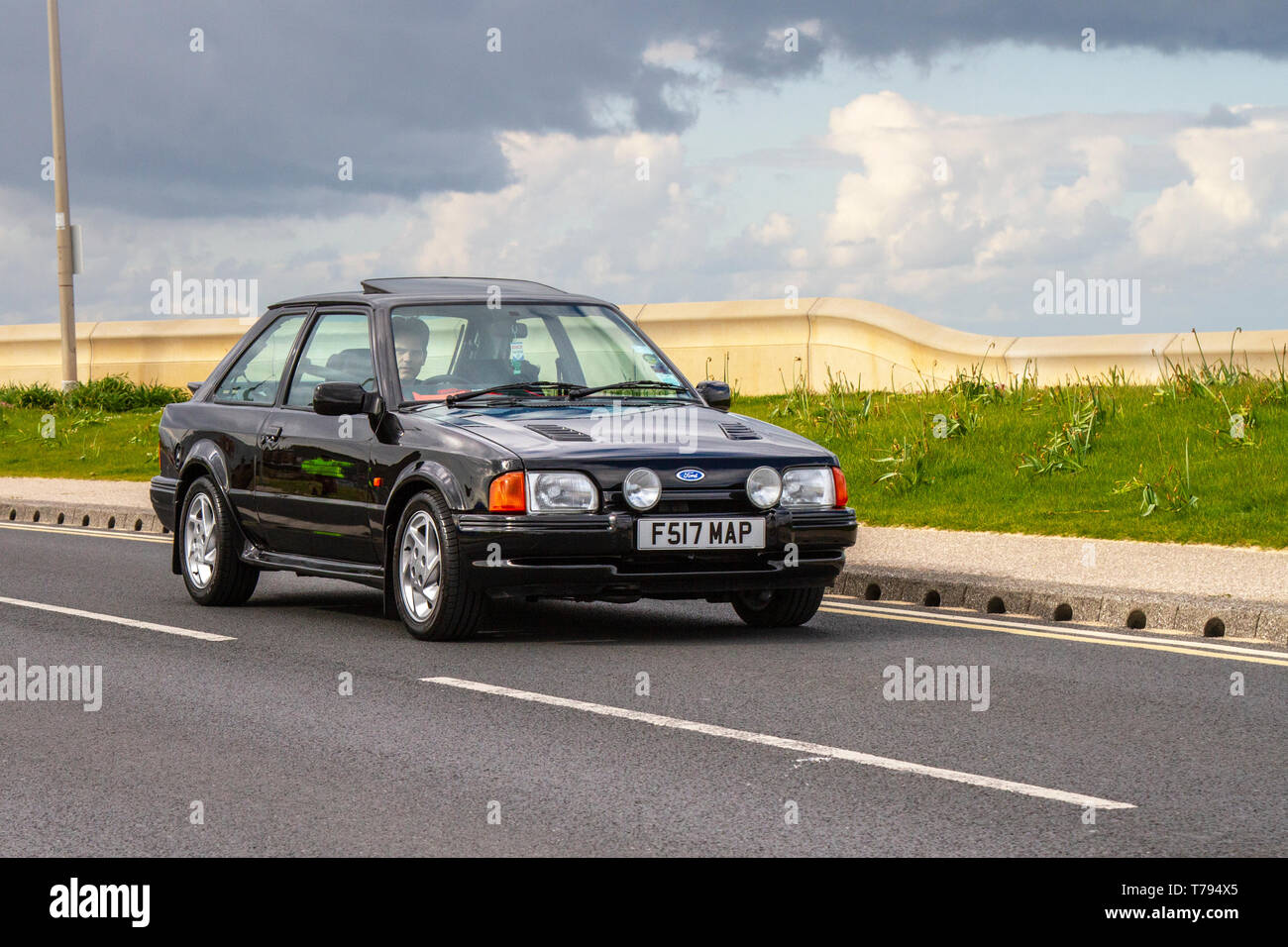 1989 80s eighties black Ford Escort RS Turbo at Cleveleys Spring Car Show at  A new location for Classic cars, veteran, retro collectible, restored, cherished old timers, heritage event, vintage, automobile Vehicle show by Blackpool Vehicle Preservation Group (BVPG). Stock Photo