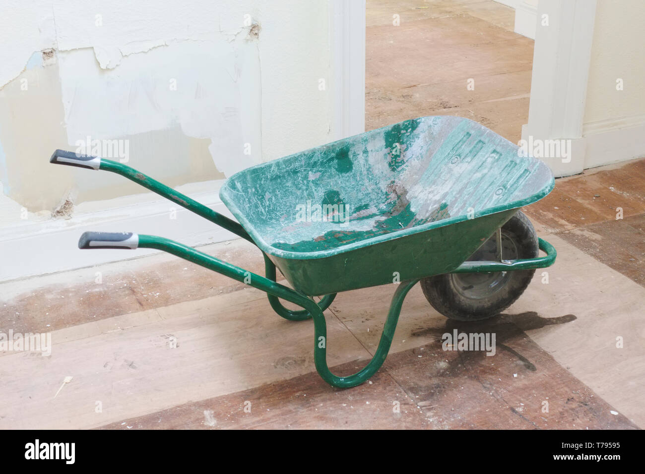 Green wheelbarrow tradesman or labourer tools for manual hand work in