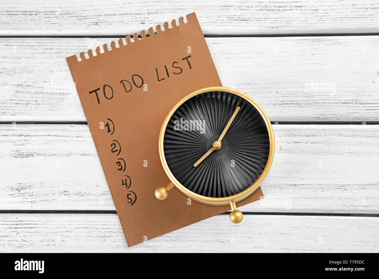 Alarm clock with to-do list on wooden background. Time management ...