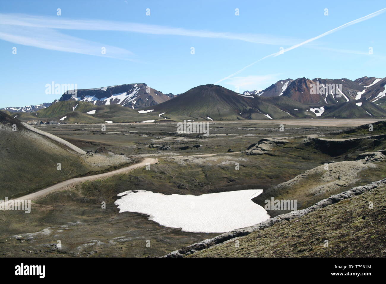 Spot of white melted rest of snow in barren black volcanic valley around Laki volcano