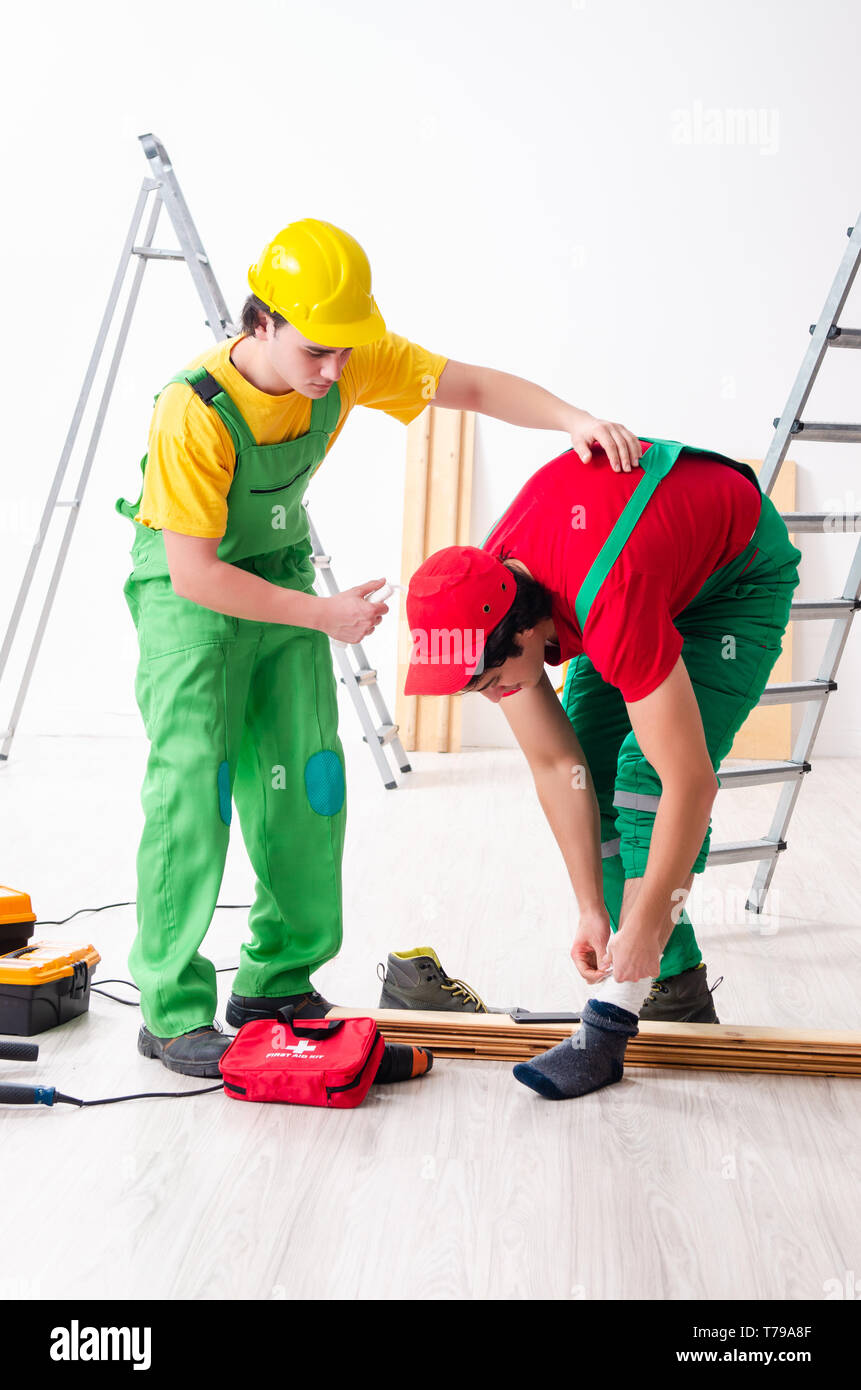 Injured worker and his workmate Stock Photo