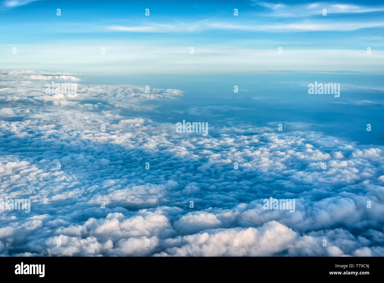 Aerial view of monsoon clouds spread over the wide expanse of plains of India. Cumulonimbus and Cumulus clouds are visible in the frame. Stock Photo