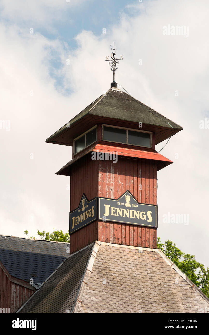 Jennings Brewery sign and weather vane on tower above the buildings in Cockermouth, Cumbria, England, UK Stock Photo