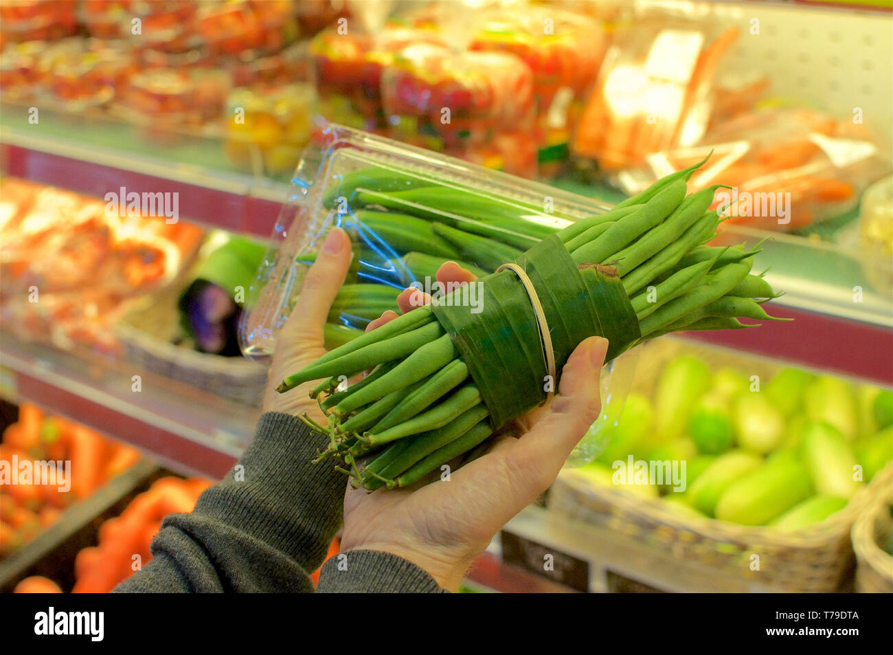 Okra bundled in a plastic package and beans wrapped in Banana leaf held