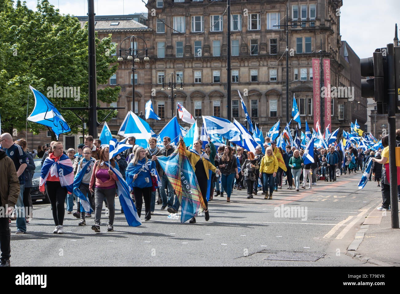 Pro-Independence demonstrators continue to march past George Square, Saltires and other pro-Independence flags held high. Stock Photo