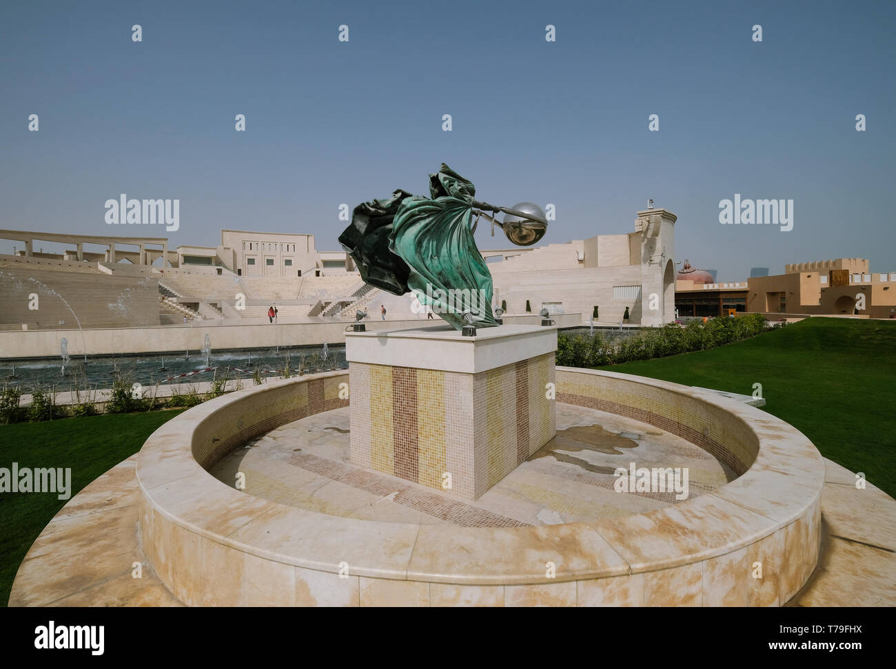 Katara Amphitheater statue - Force of Nature II by Lorenzo Quinn with Katara Village Amphitheater in the background. Stock Photo