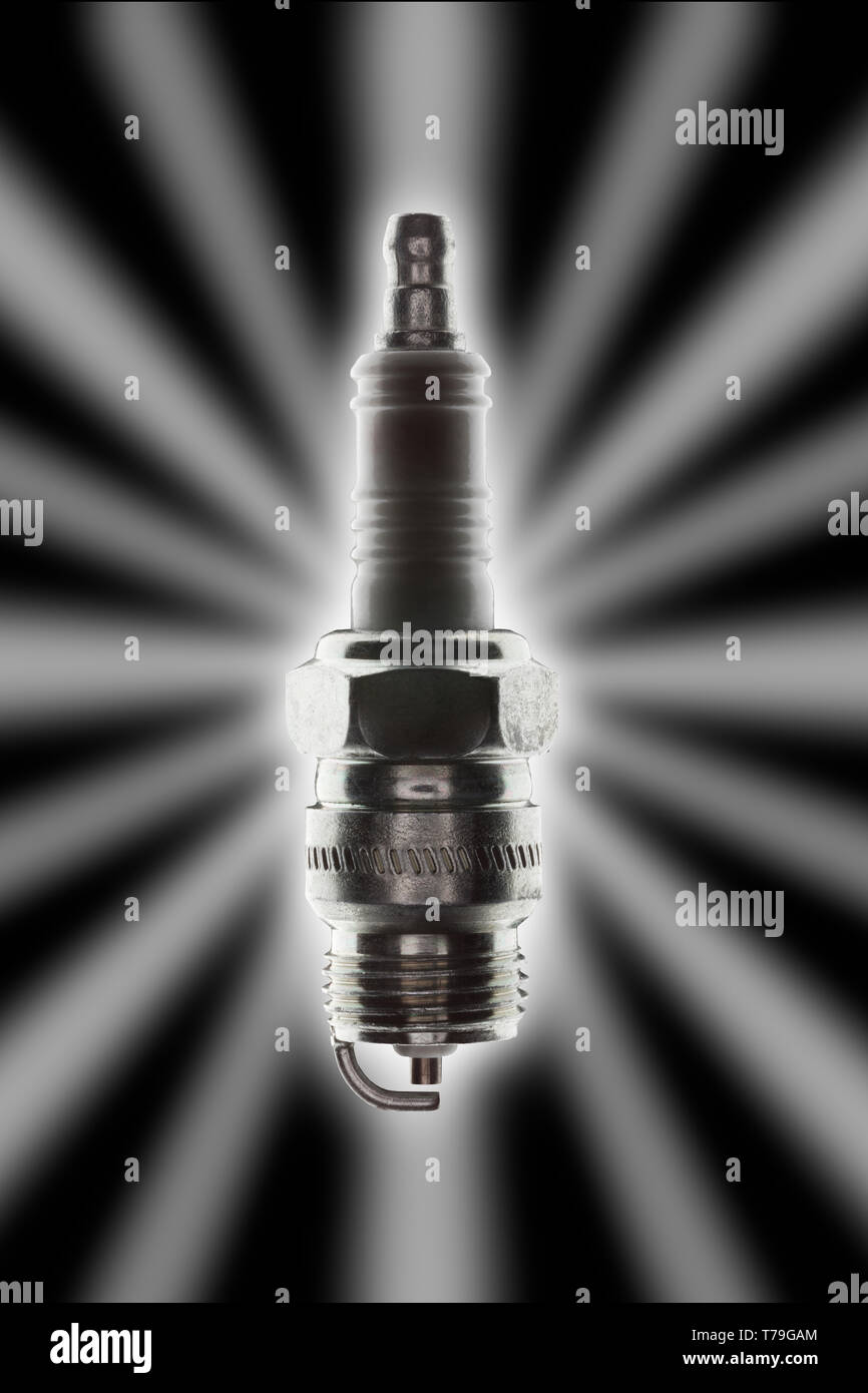 single spark plug with strong backlight glow and star effect on a black background Stock Photo