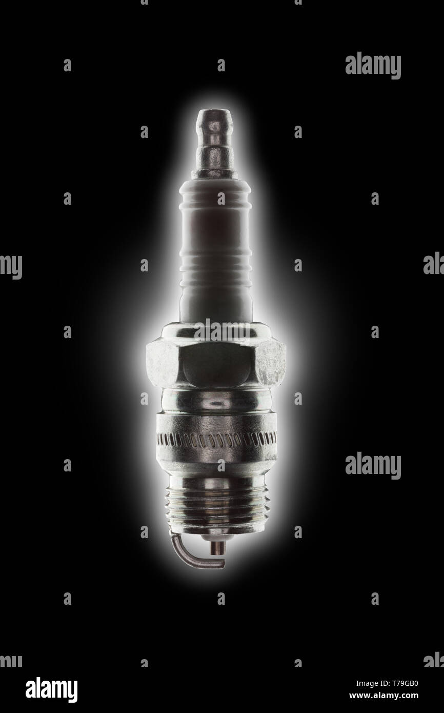 single spark plug with strong backlight glow on a black background Stock Photo