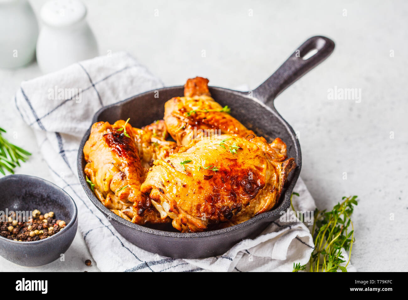 Grilled chicken in cast iron skillet, white background Stock Photo Alamy