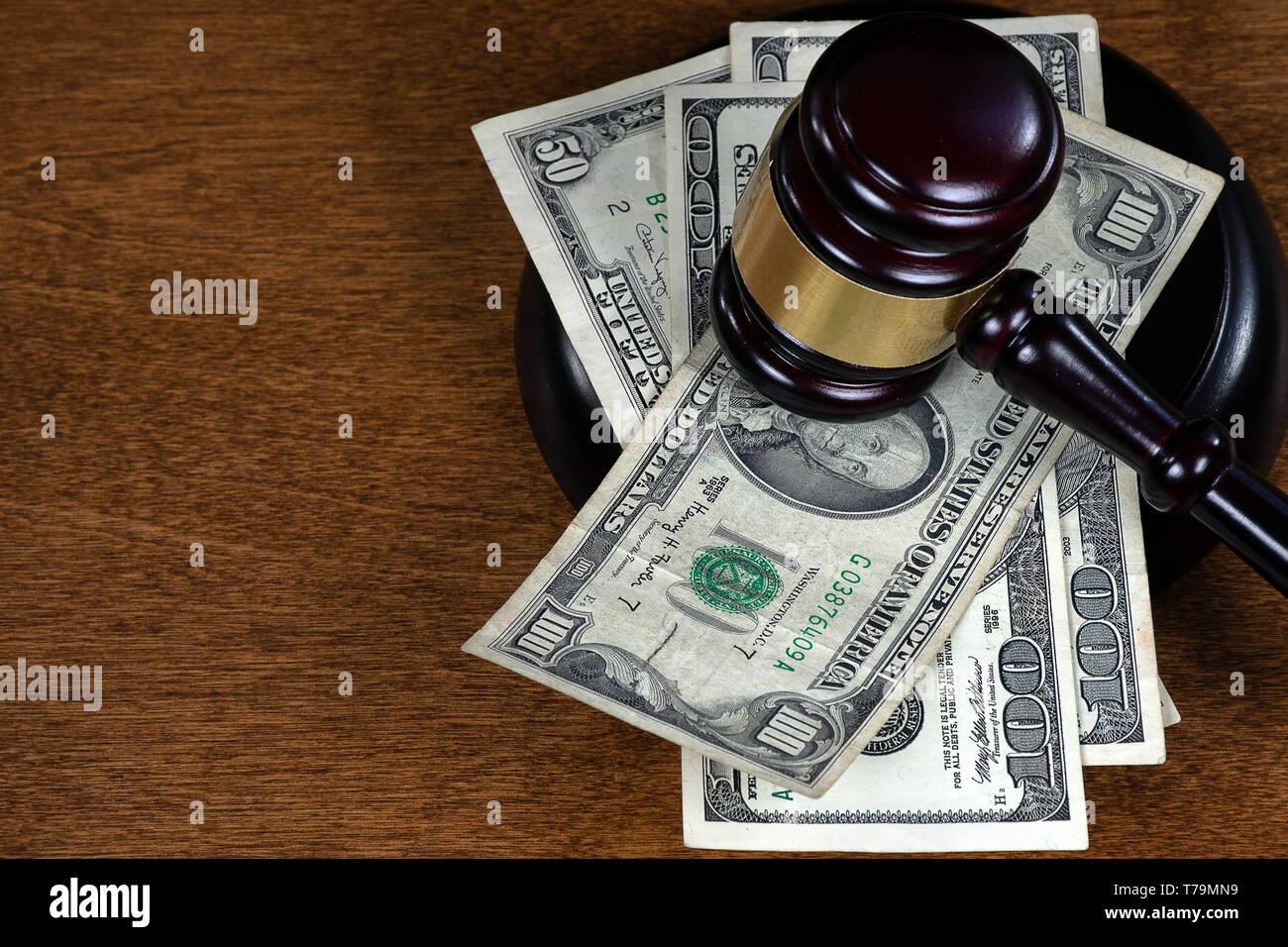 wooden courtroom gavel on American currency Stock Photo