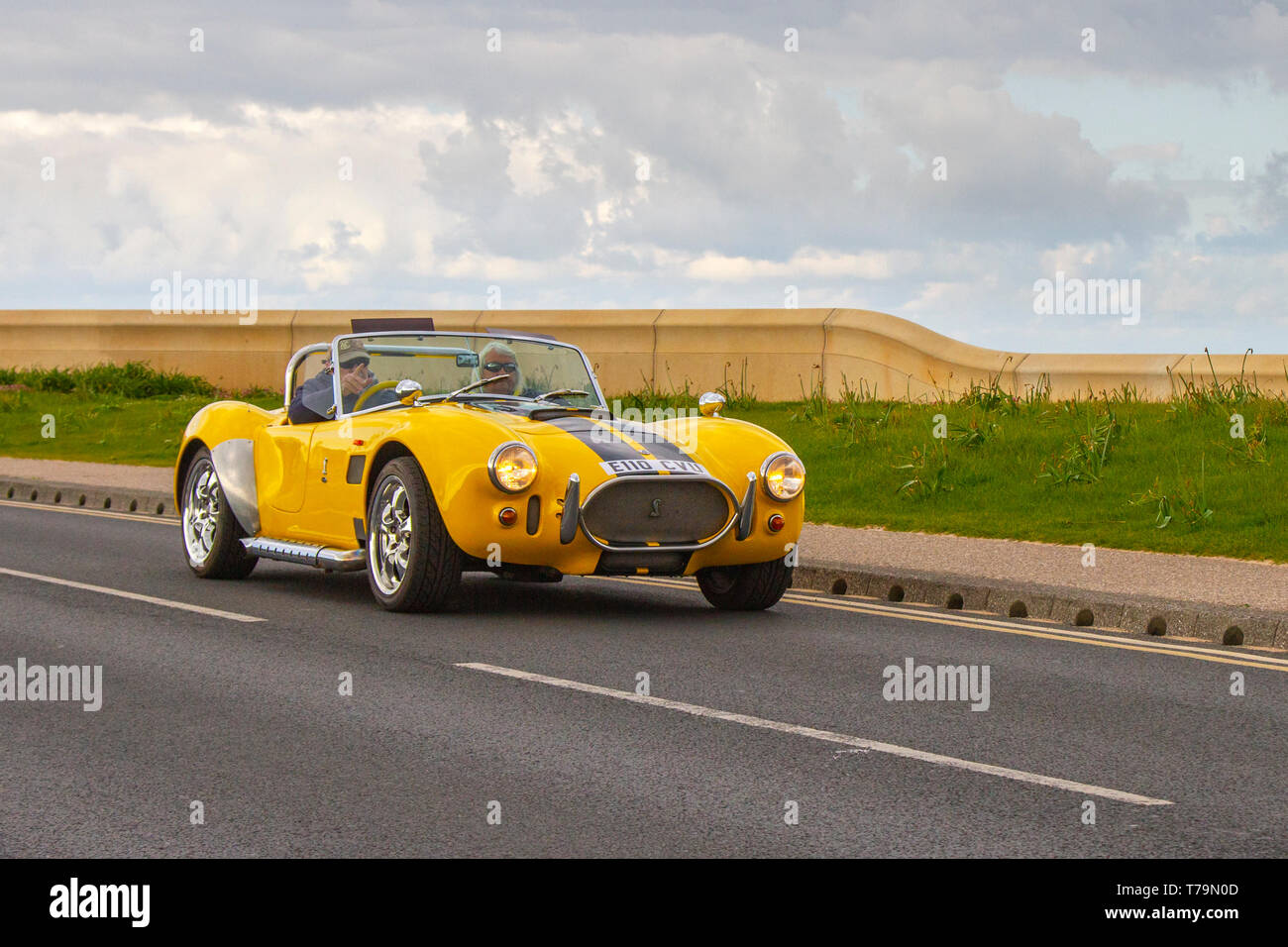 2002 yellow AC Cobra Sports Cars Fiero Factory Euro at Cleveleys Spring Car Show at Jubilee Gardens.  A new location for Classic cars, veteran, retro collectible, restored, cherished old timers, heritage event, vintage, automobile Vehicle show by Blackpool Vehicle Preservation Group (BVPG). Stock Photo