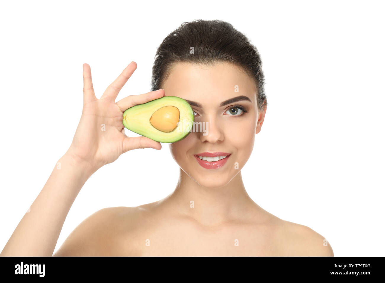 Beautiful young woman with avocado on white background Stock Photo Alamy