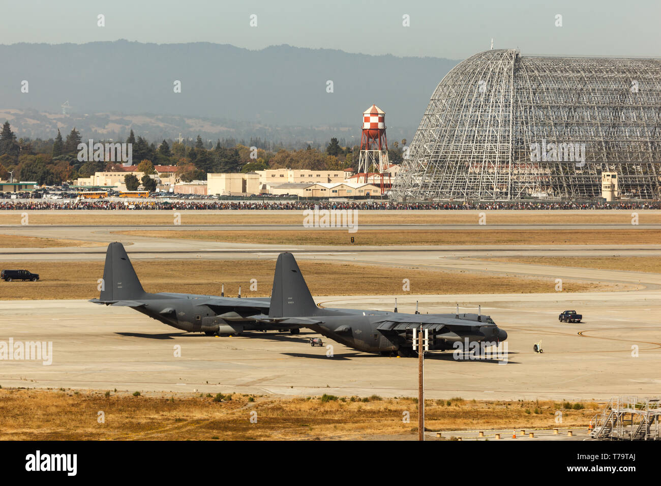 Closeup of military airfield with two cargo planes parked together on taxiway in San Francisco Stock Photo