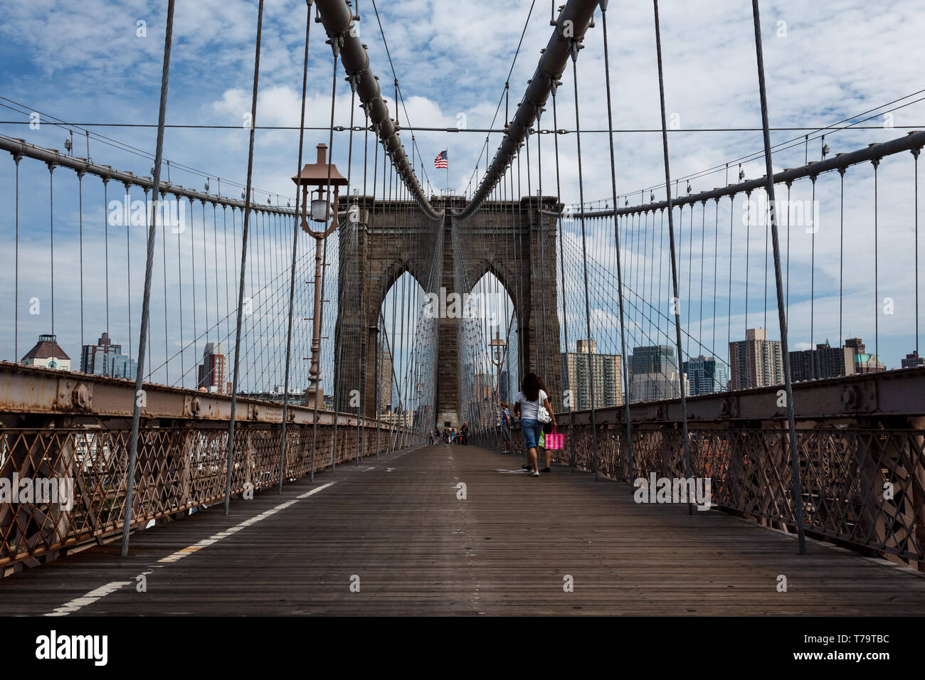 Pedestrian walkway on famous Brooklyn bridge connecting to New York City Stock Photo
