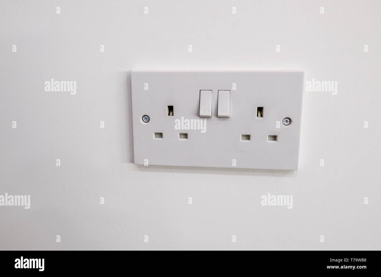 Double white plastic electric plug with two switches to turn on and off Stock Photo Alamy
