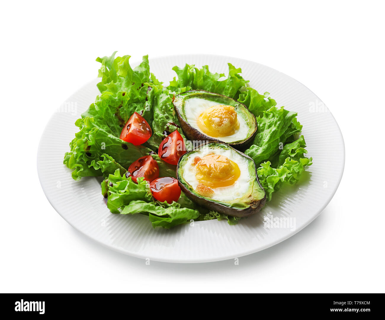 Baked avocado with eggs and vegetables on white background Stock Photo ...