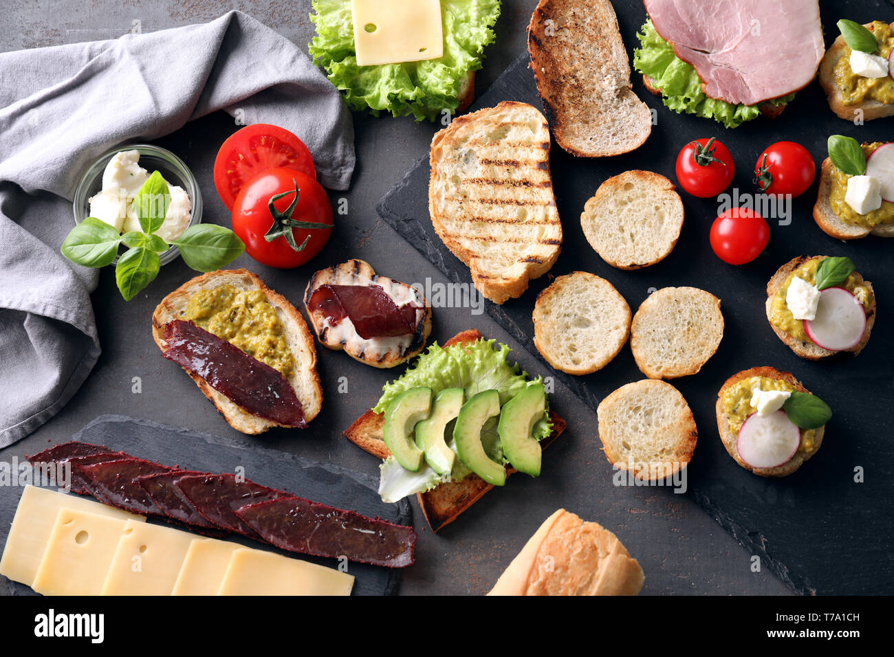 Different delicious toasts on table Stock Photo - Alamy