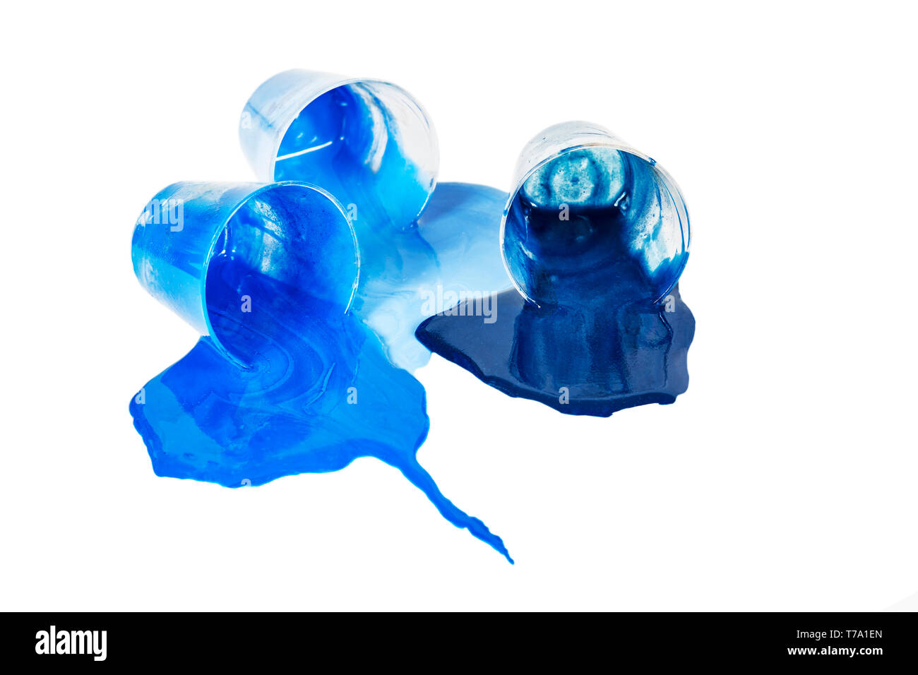 Small bowl of three shades of blue acrylic paint laying on its side