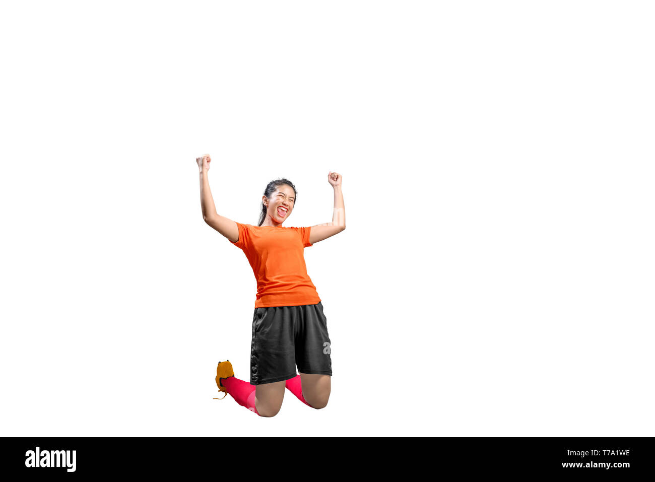 Asian football player woman celebrate her goal with raised arms and