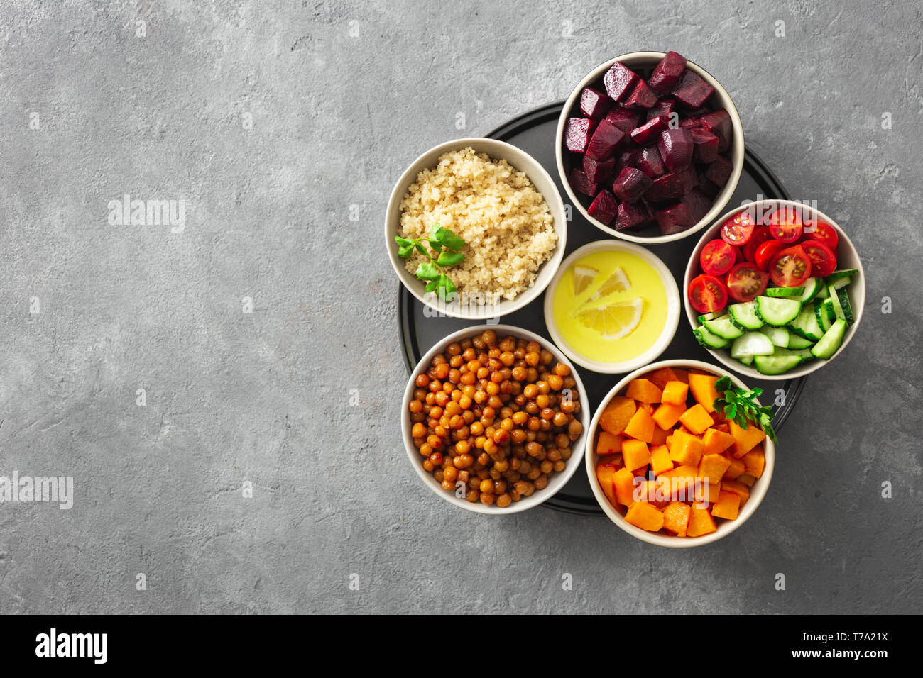 Healthy vegetarian ingredients for cooking moroccan salad. Chickpeas, Baked pumpkin and beets, quinoa and vegetables top view Stock Photo