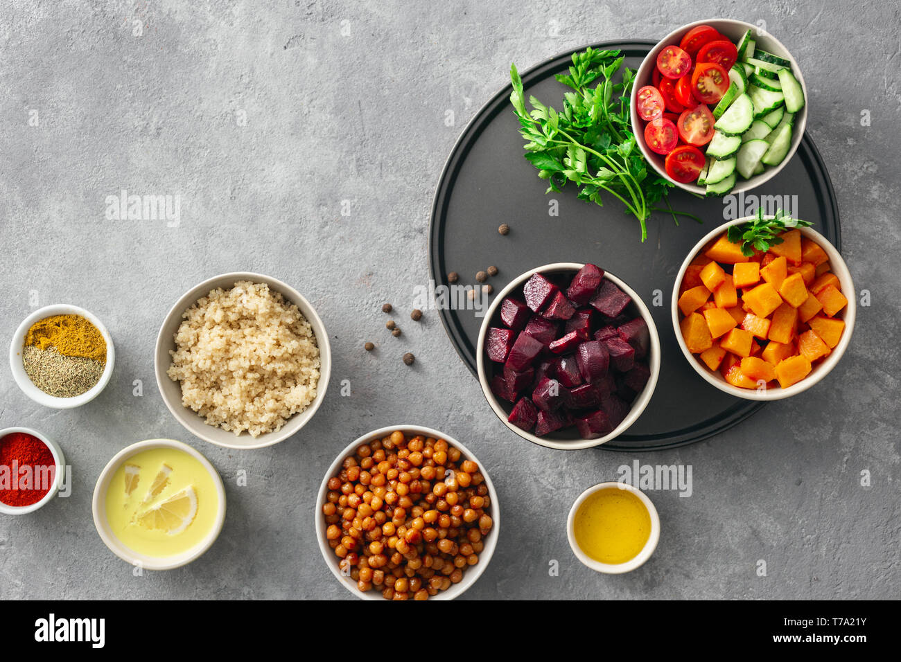 Set food for cooking healthy vegetarian food. Spiced chickpeas, baked pumpkin and beets, quinoa and vegetables top view Stock Photo