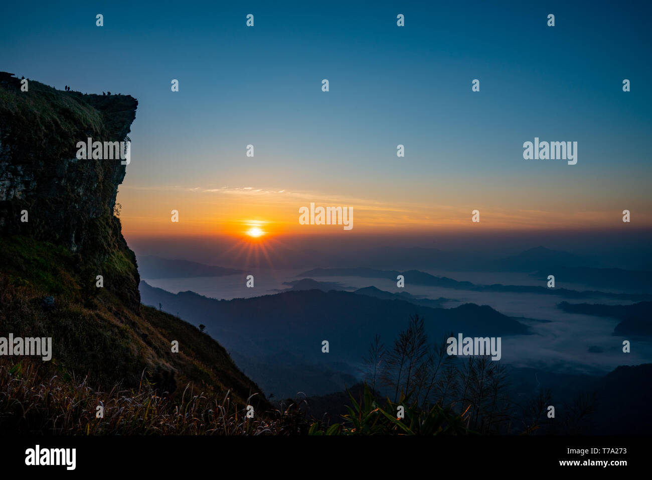 The sunrise at the mountain with the fog and cloud cover it Stock Photo ...