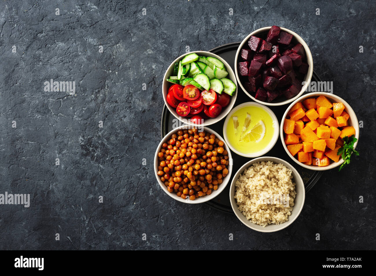 Healthy vegetarian ingredients for cooking moroccan salad. Chickpeas, Baked pumpkin and beets, quinoa and vegetables top view copy space Stock Photo