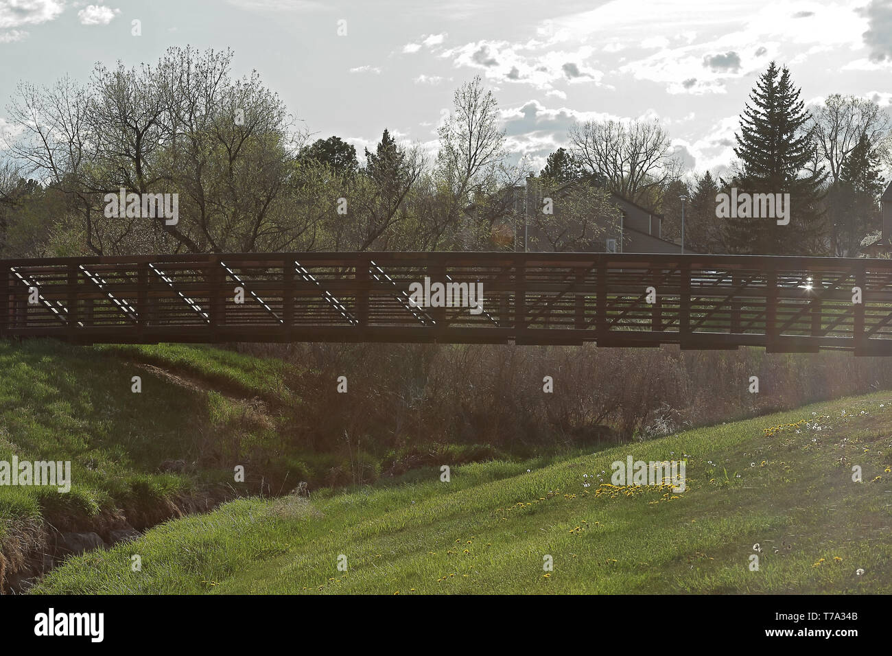 Beautiful landscape with pedestrian bridge in the small neighborhood park, Aurora, Colorado Stock Photo