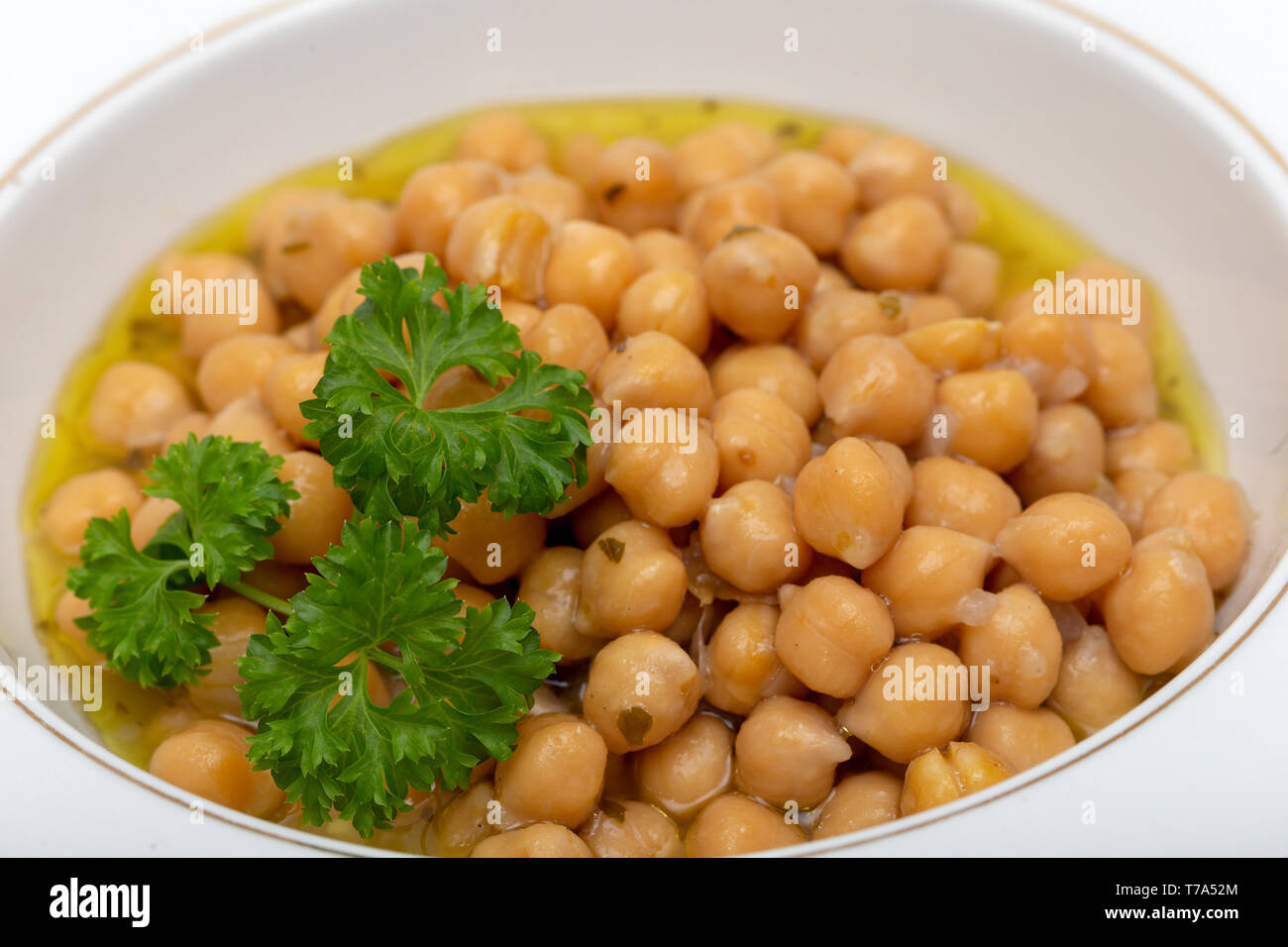Greek chickpea soup (revithia soupa) garnished with parsley. It's made with olive oil, onion, water, oregano, garlic, bay leaf, lemon juice, flour and Stock Photo