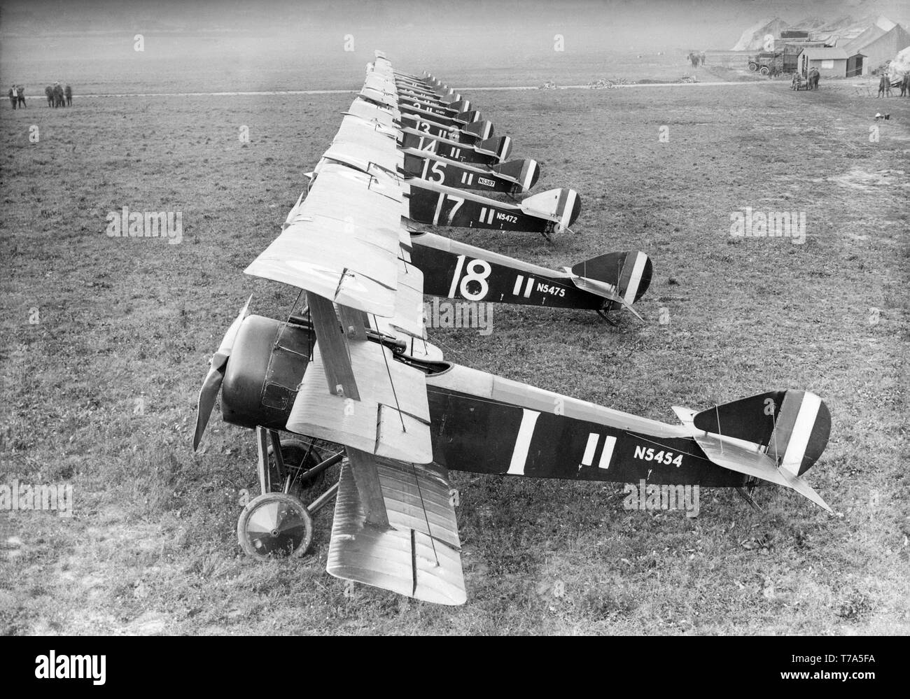 A line up of Sopwith Triplanes of the British Royal Air Force or Royal Flying Corps at an airfield during World War One. Serial numbers N5454 and N5475 nearest the camera. Stock Photo
