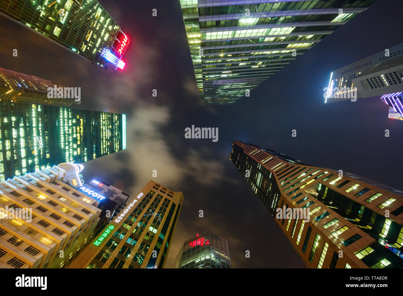 Tall office builings at Collyer Quay in the Central Business District (CBD) pointing towards a dark sky. Singapore Stock Photo