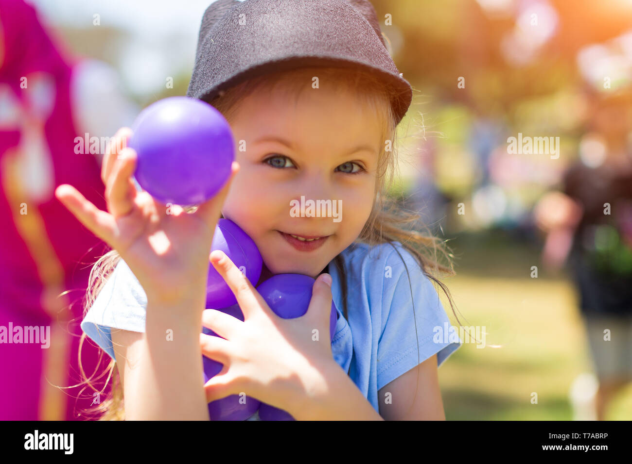 Happy little kid playing at colorful plastic balls playground high view