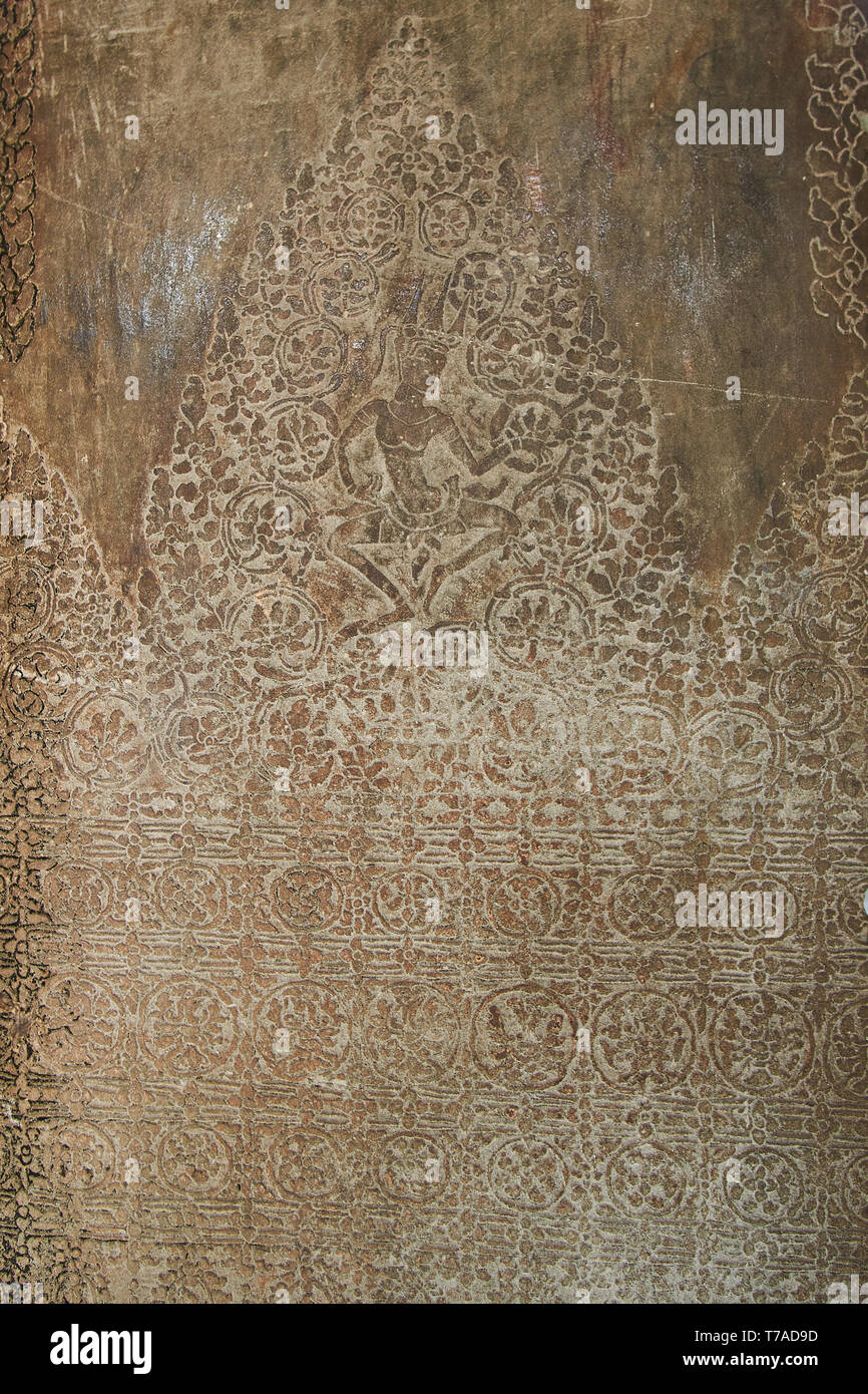Angkor Pattern Engraved patterns, designs, and deity on the wall of a hallway inside ...
