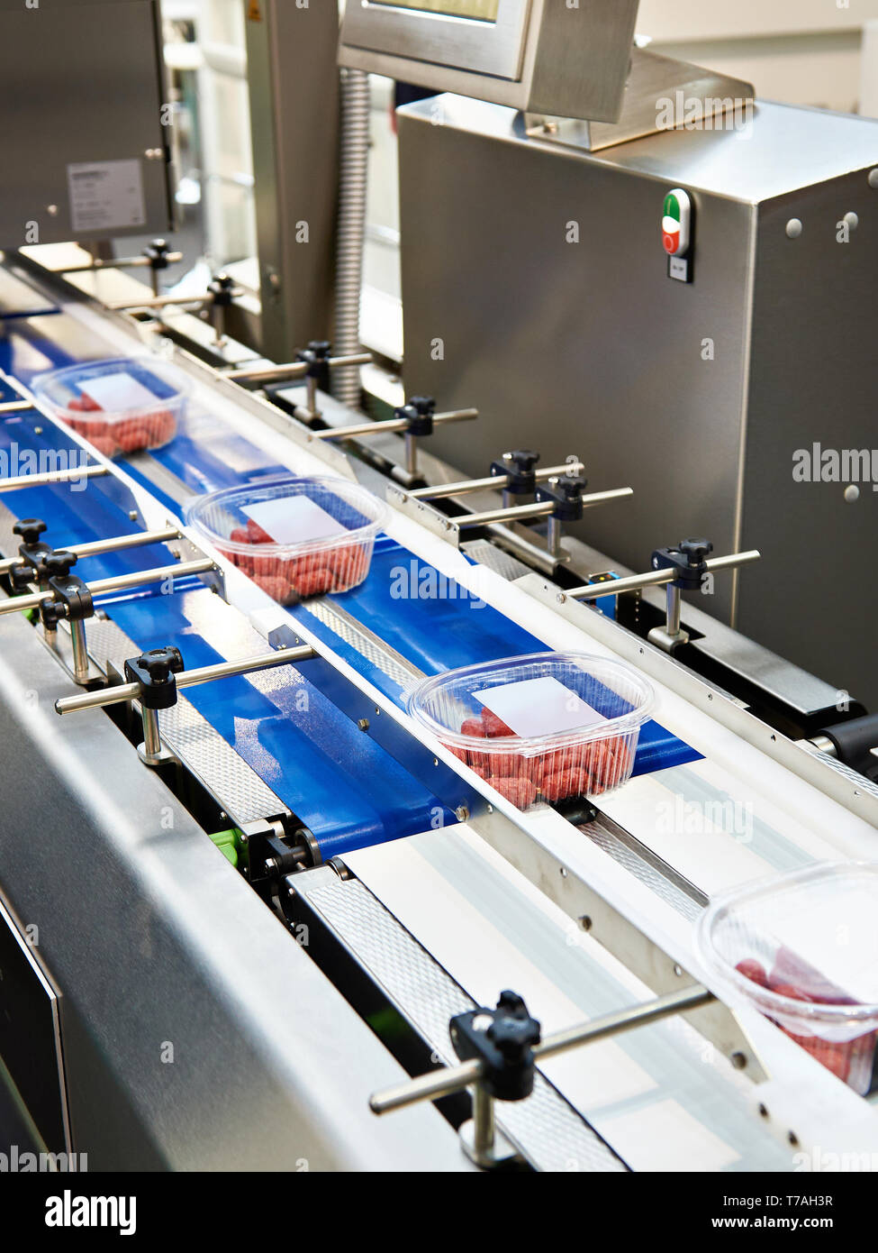 Plastic container packaging system and conveyor belt Stock Photo - Alamy