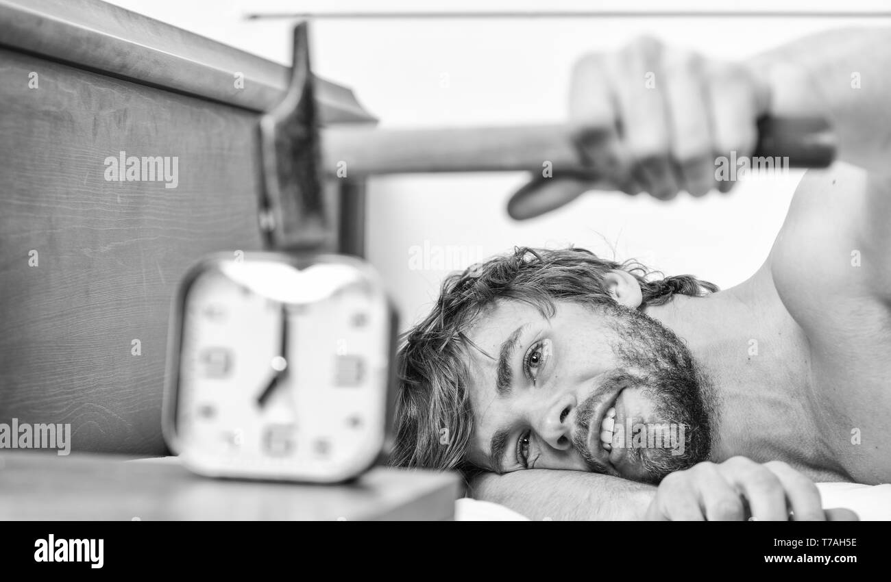 Stop ringing. Annoying ringing alarm clock. Man bearded annoyed sleepy