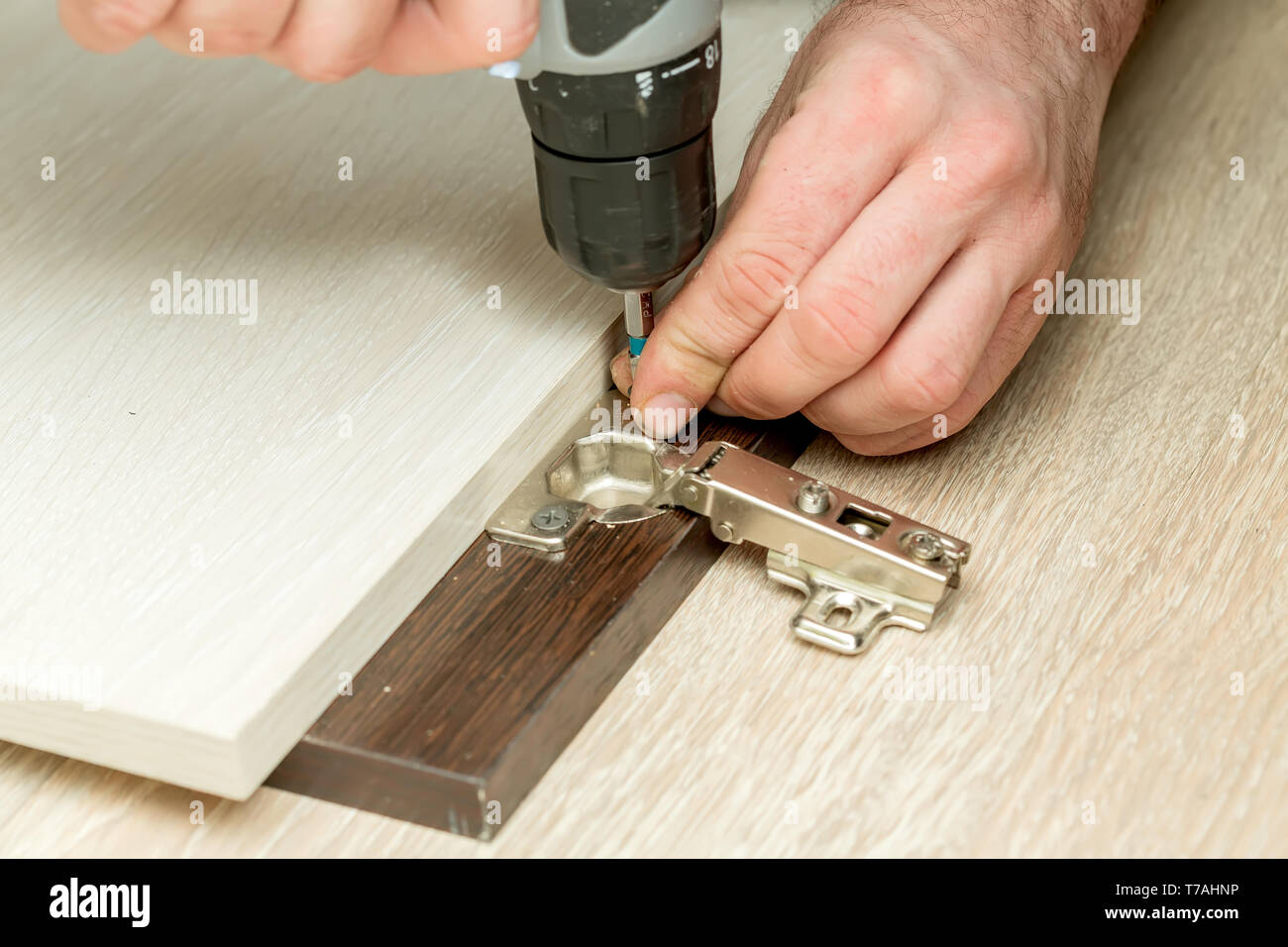 Fixing door furniture hinges. Fixing furniture hinges Stock Photo