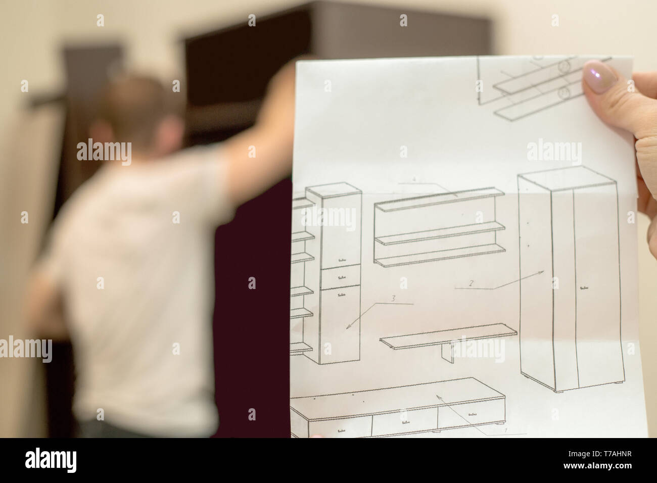 Instruction for furniture assembling in the female hand against the