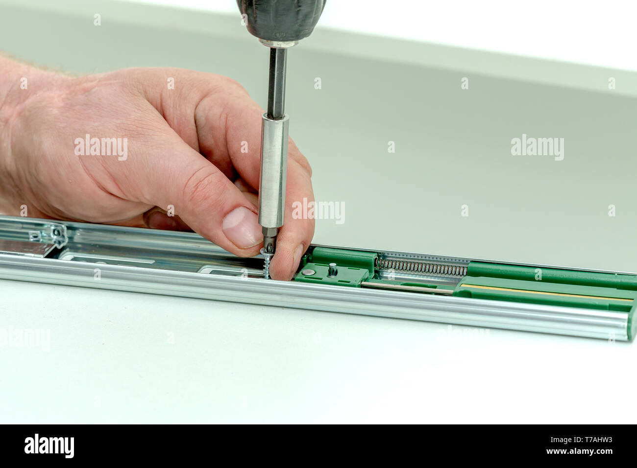 Assembling furniture from chipboard, using a cordless screwdriver, close up Stock Photo