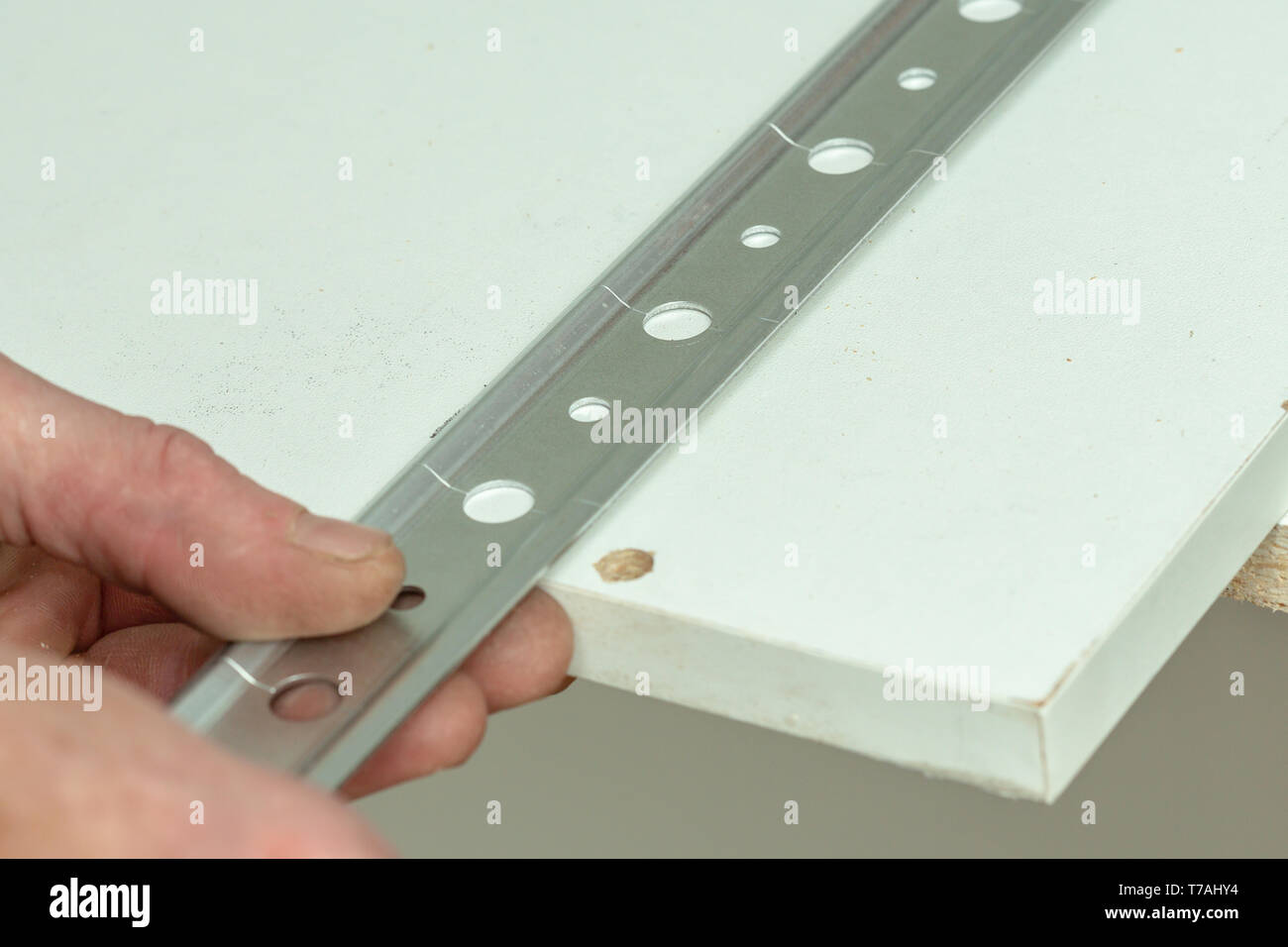 Close-up view mounting rail for mounting kitchen cabinets Stock Photo